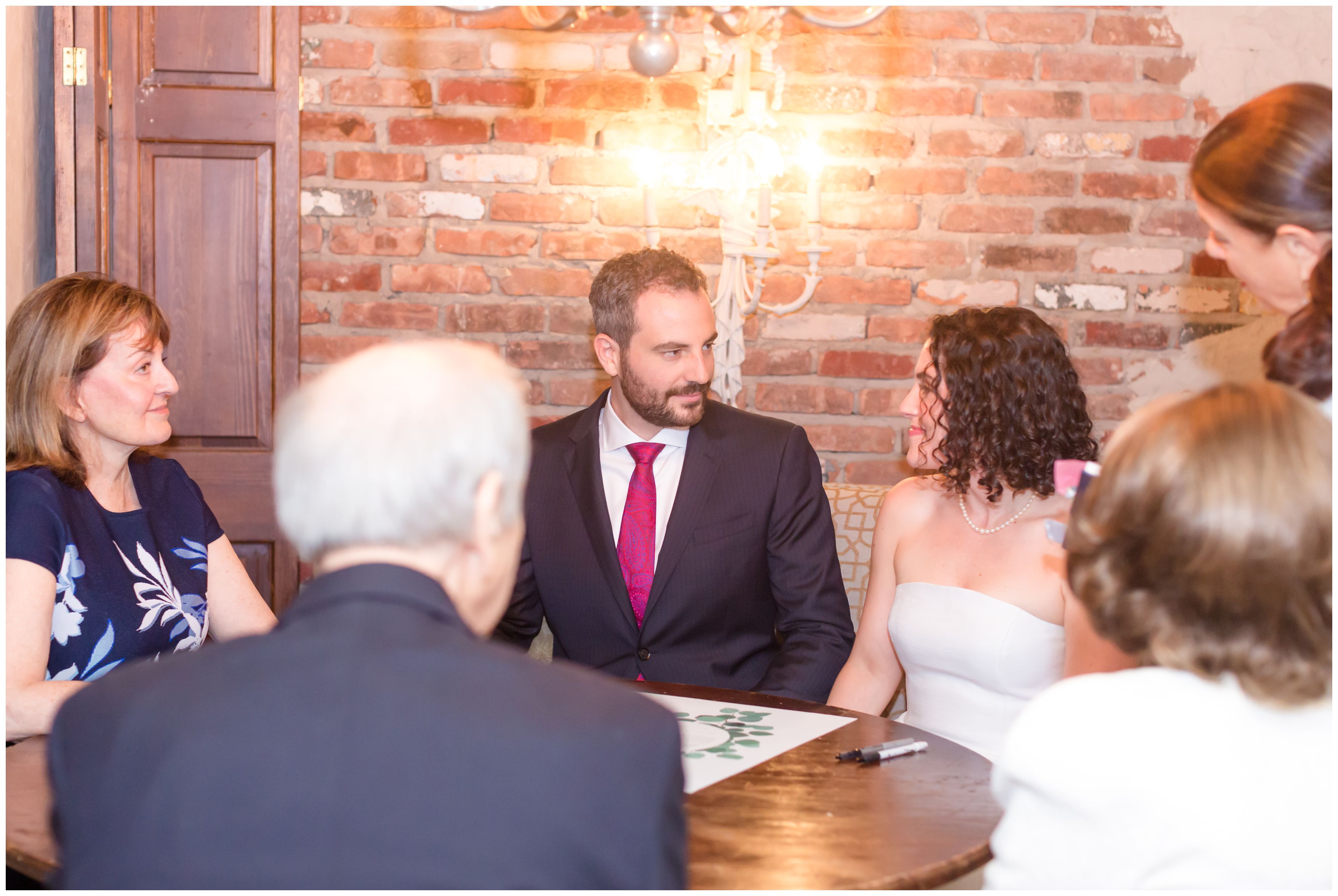 Bride and groom and family and the Ketubah signing