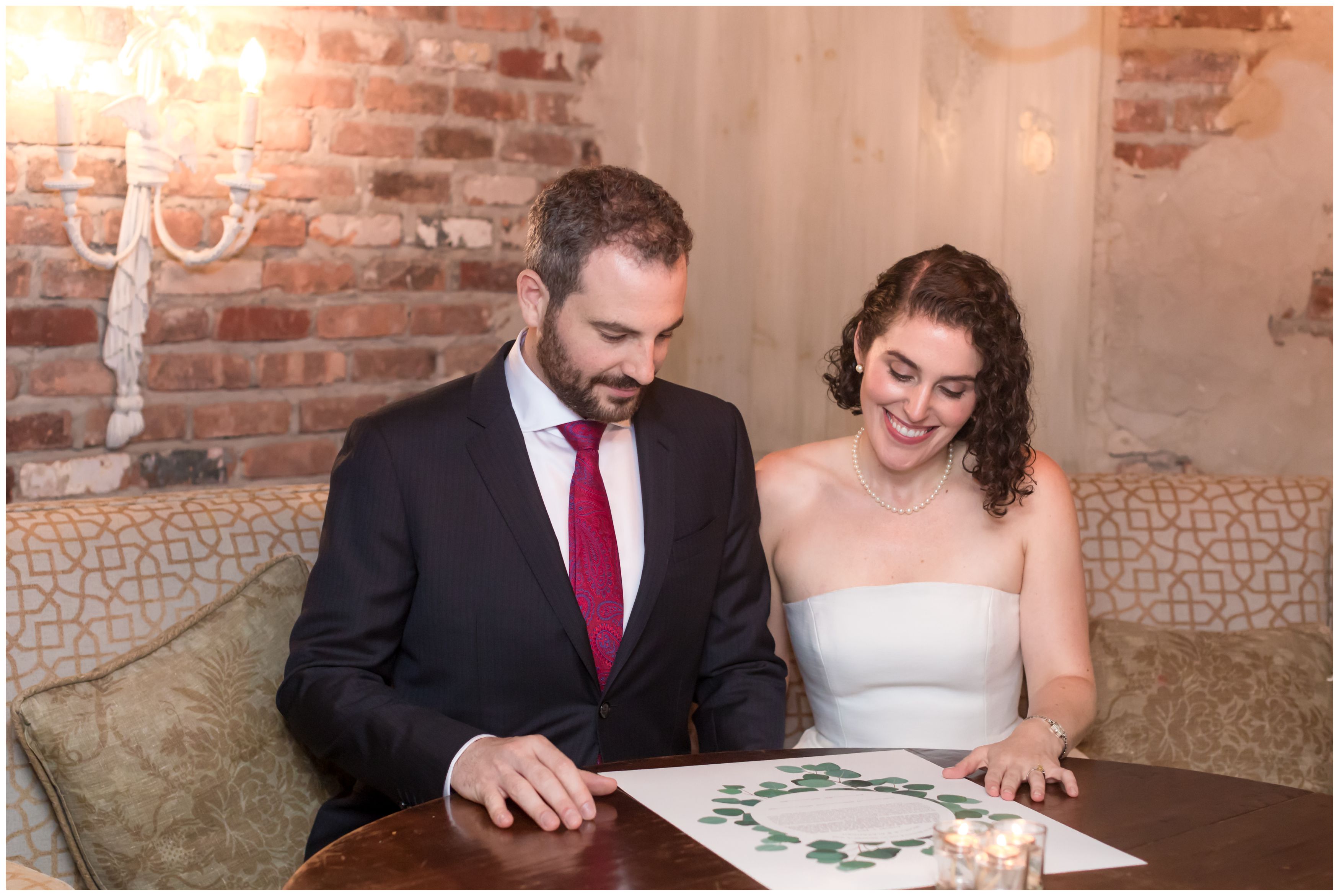 Bride and groom signing the Ketubah at the Bernards Inn