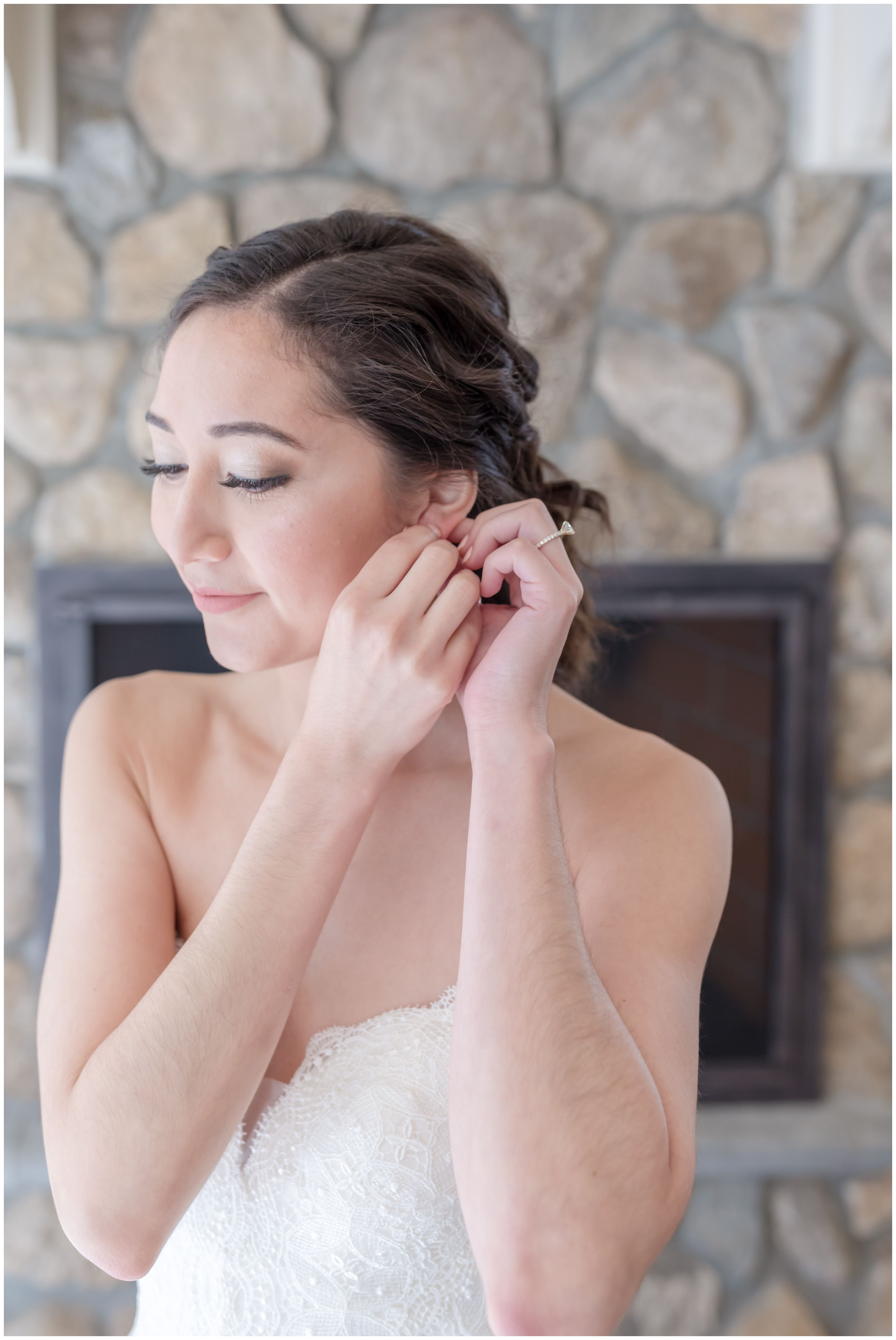 Bride getting ready earring on detail