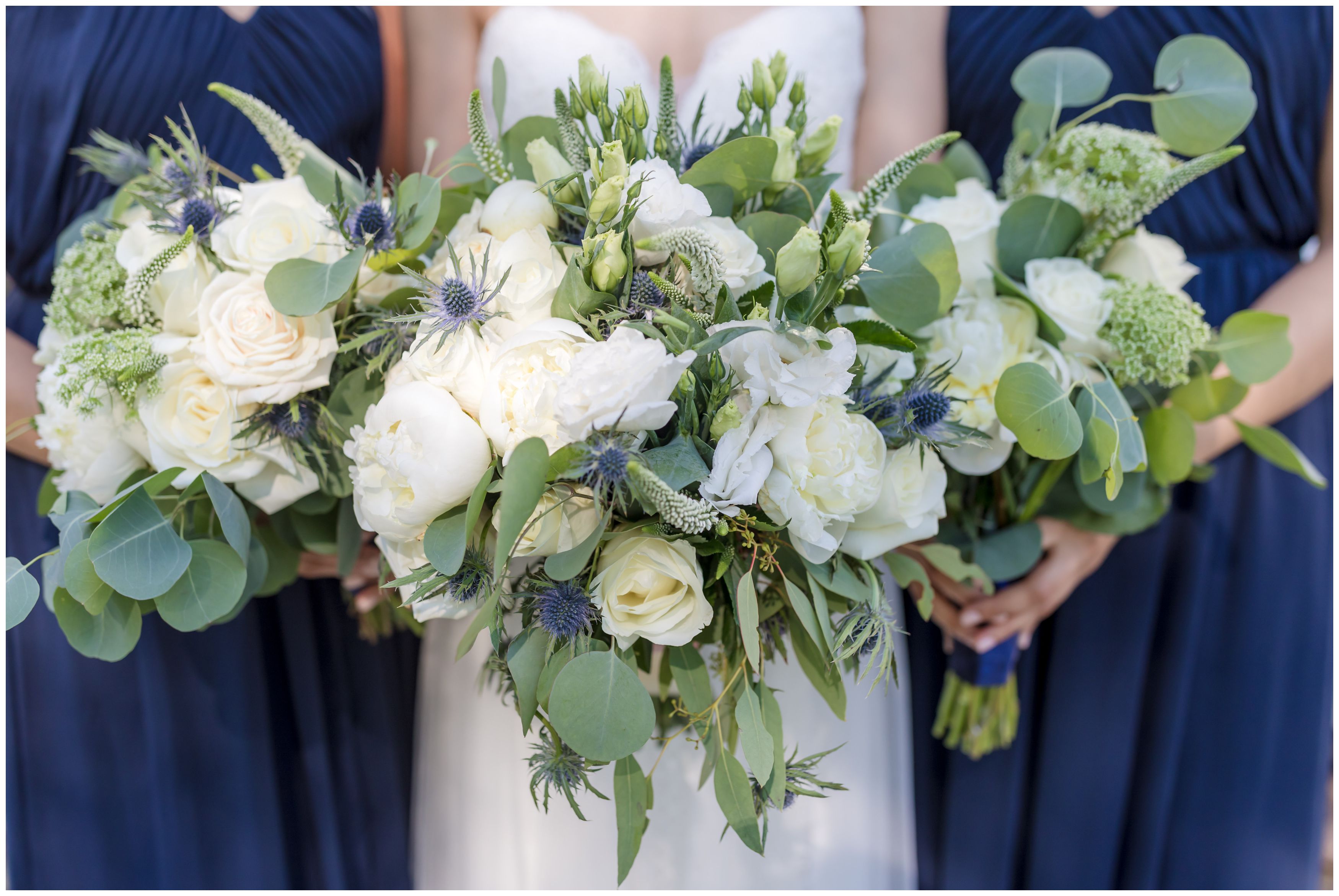 Large white peonies and white roses bride bouquet with navy bridesmaids and white roses bouquets