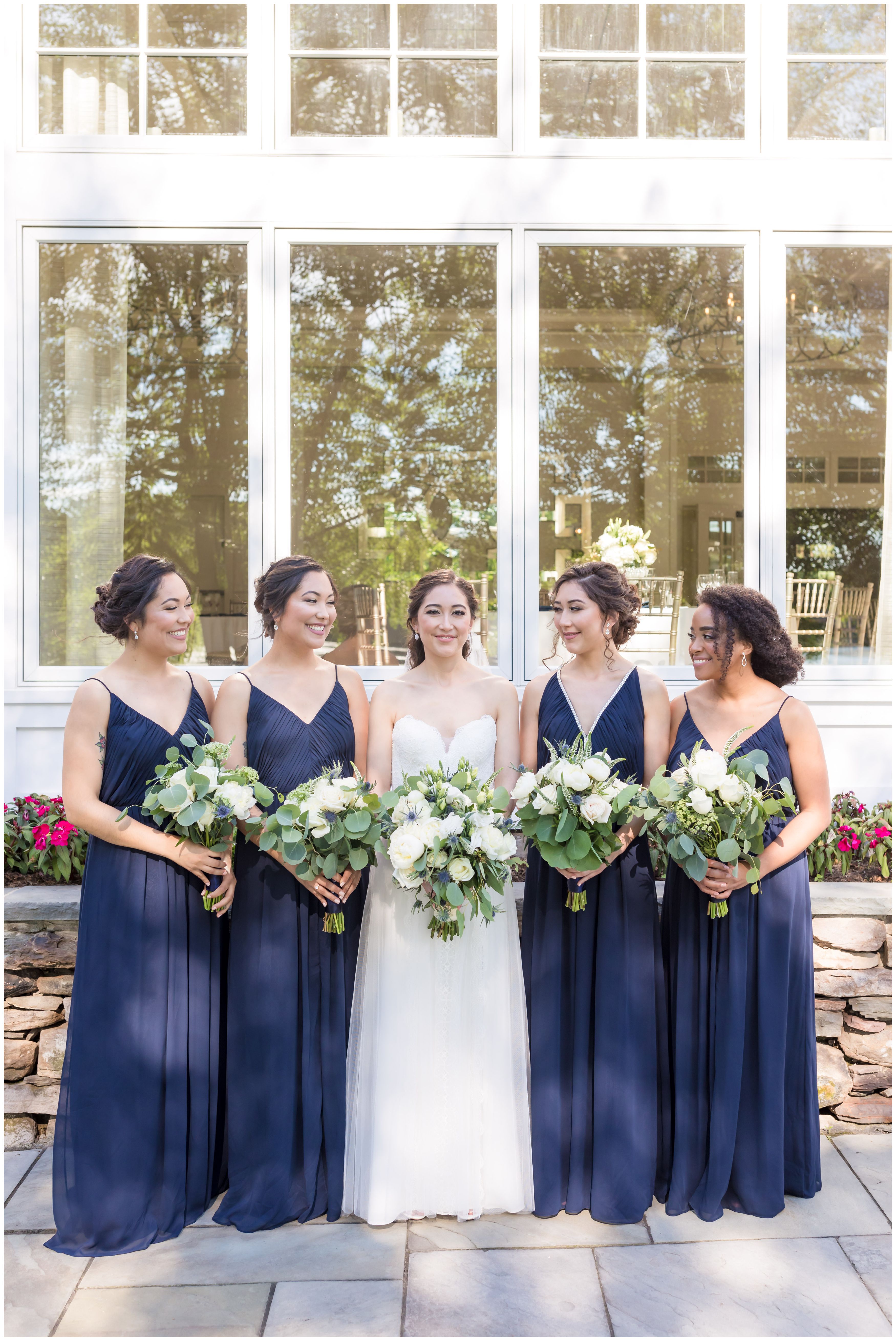 Bridal Party at Indian Trail club with large white peonies and white roses bride bouquet with navy bridesmaids and white roses bouquets