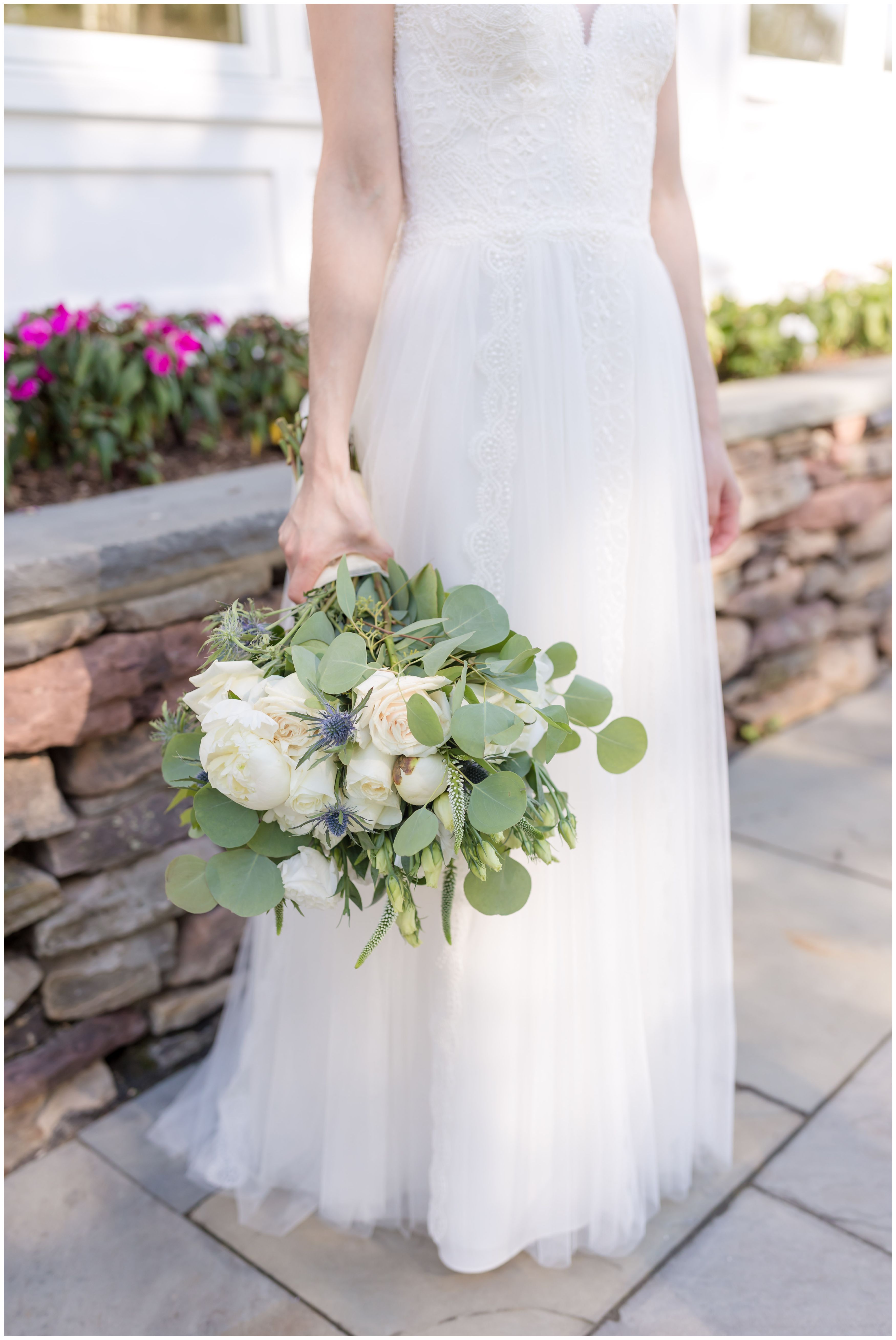 Bride and white peonies and roses bridal bouquet