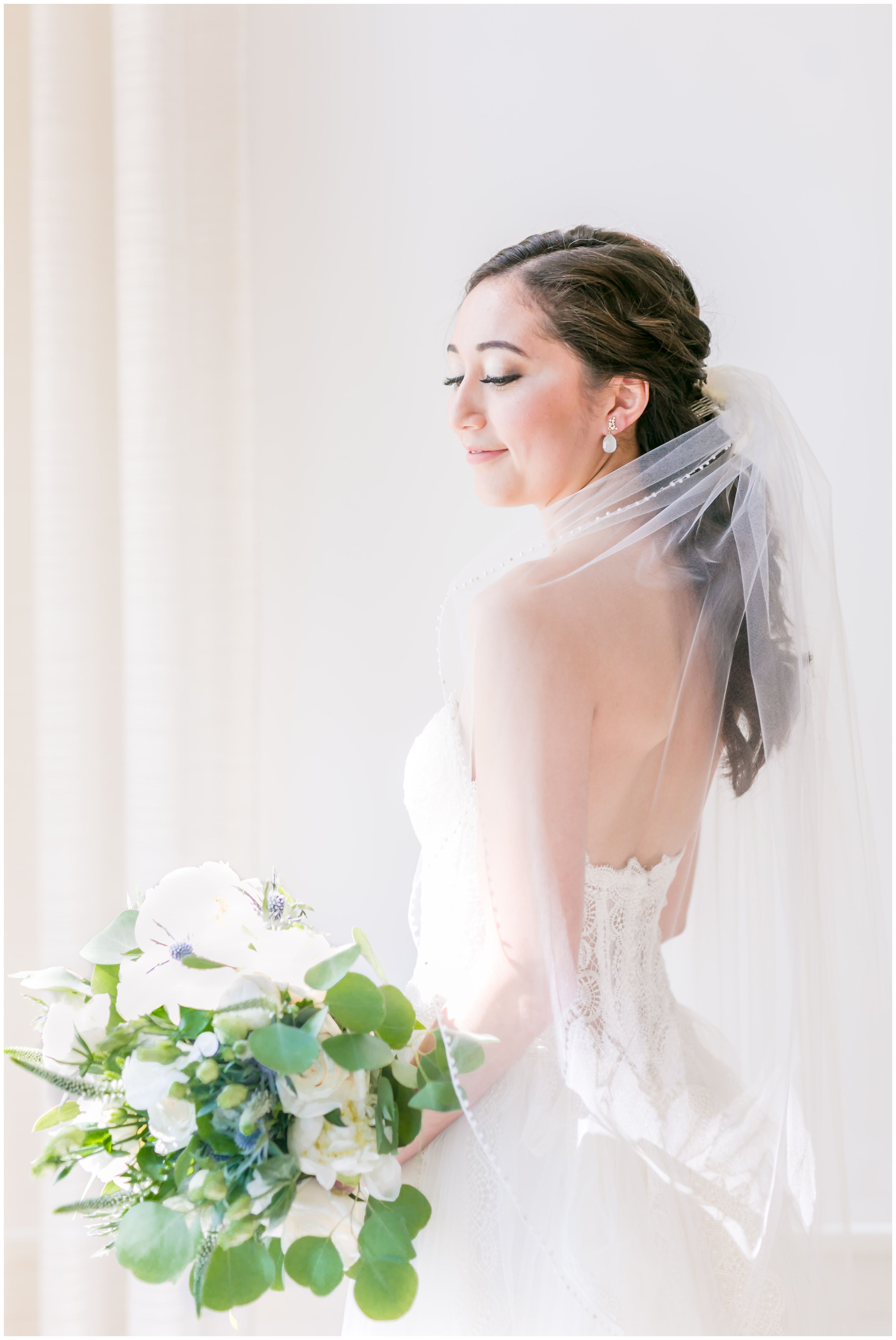 Classic bride wedding portrait with lace and tulle wedding ballgown and classic veil and white peony and rose bridal bouquet