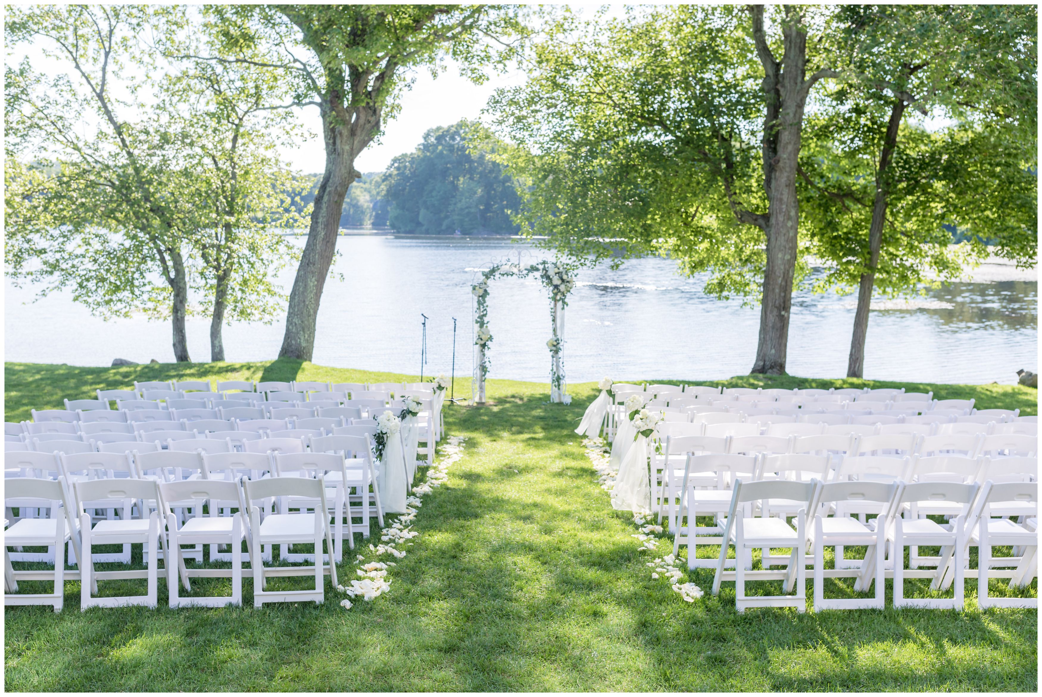 Outdoor lakeside ceremony at Indian Trail Club with white floral details