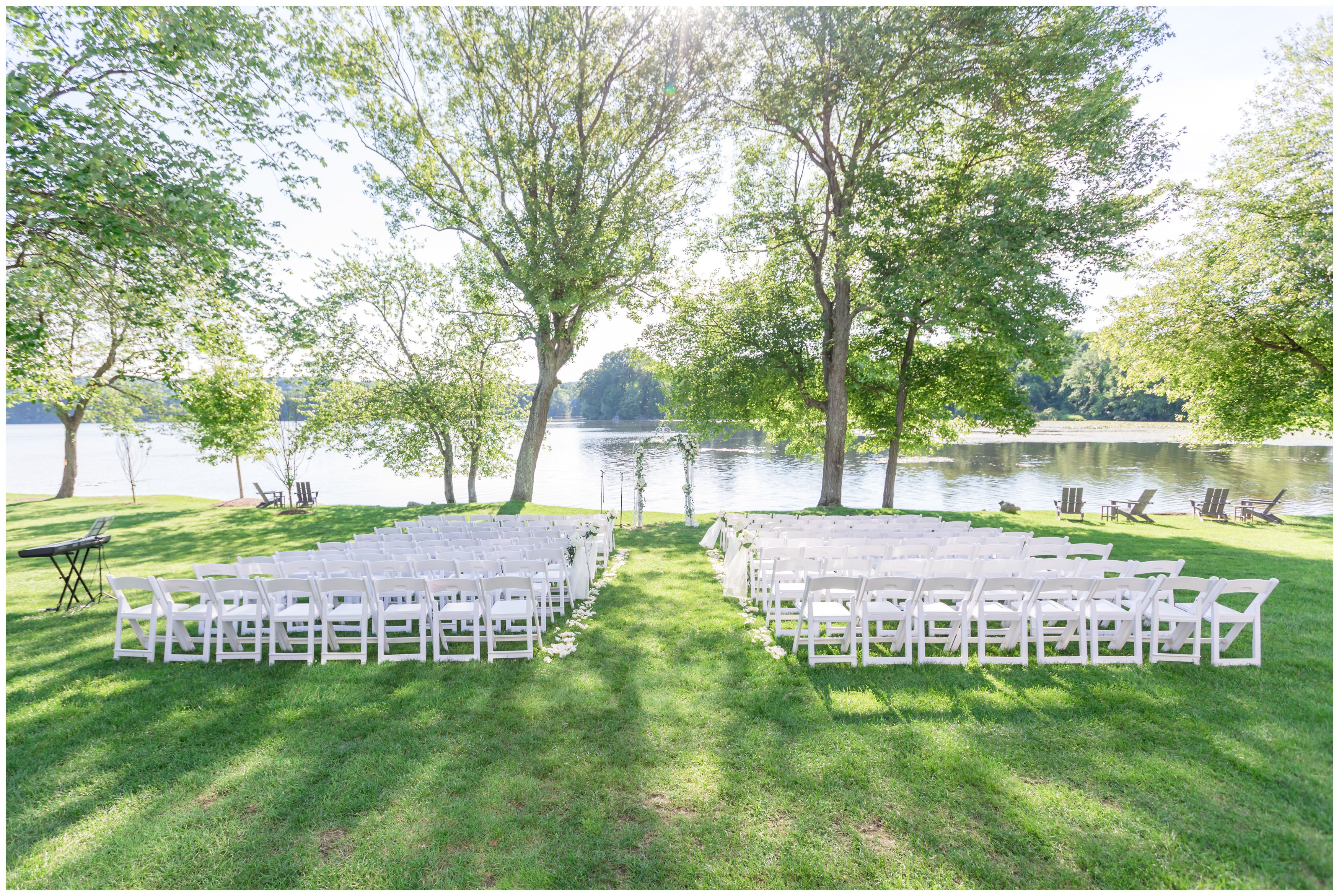 Outdoor lakeside ceremony with white floral details at Indian Trail Club