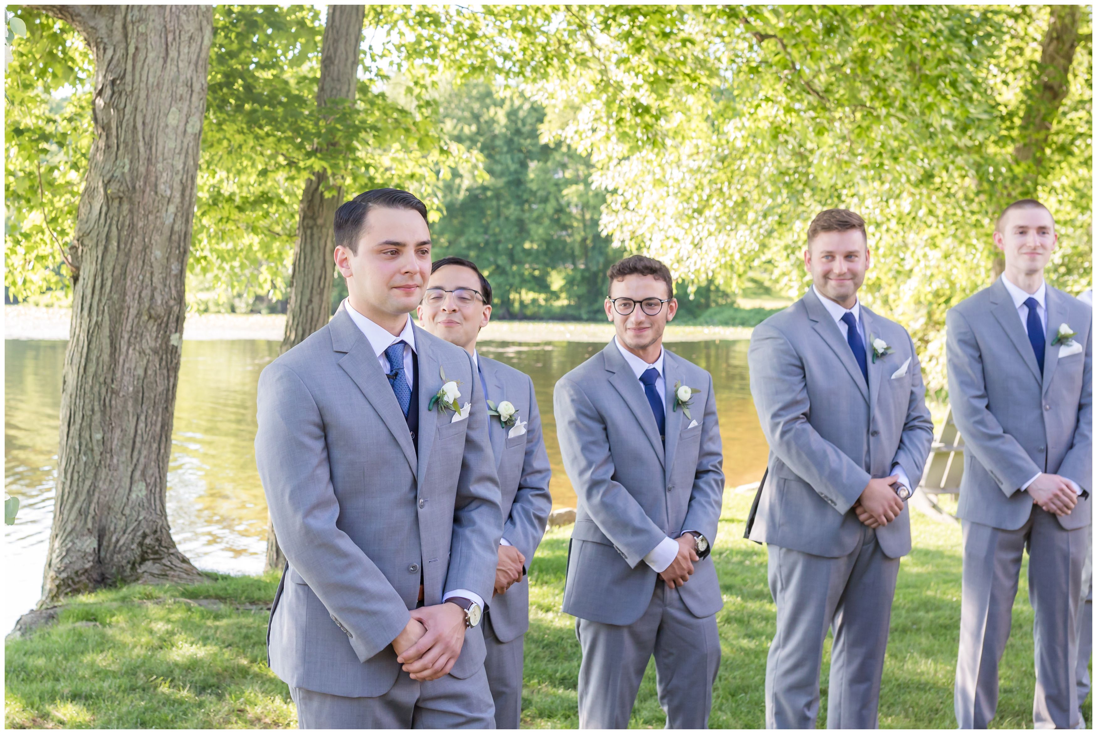 Emotional groom at outdoor lakeside ceremony