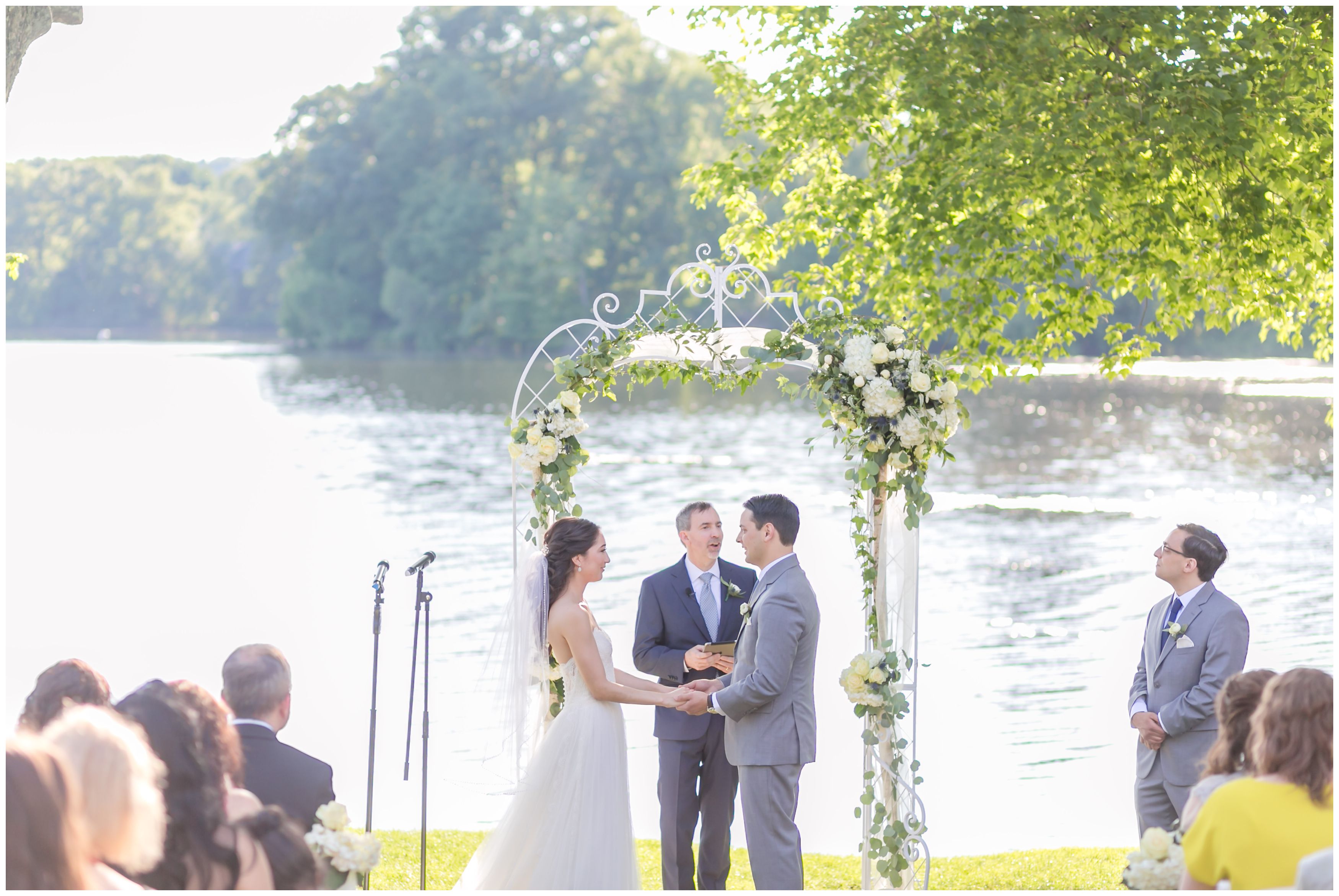 Outdoor lakeside ceremony with bride and groom at Indian Trail Club
