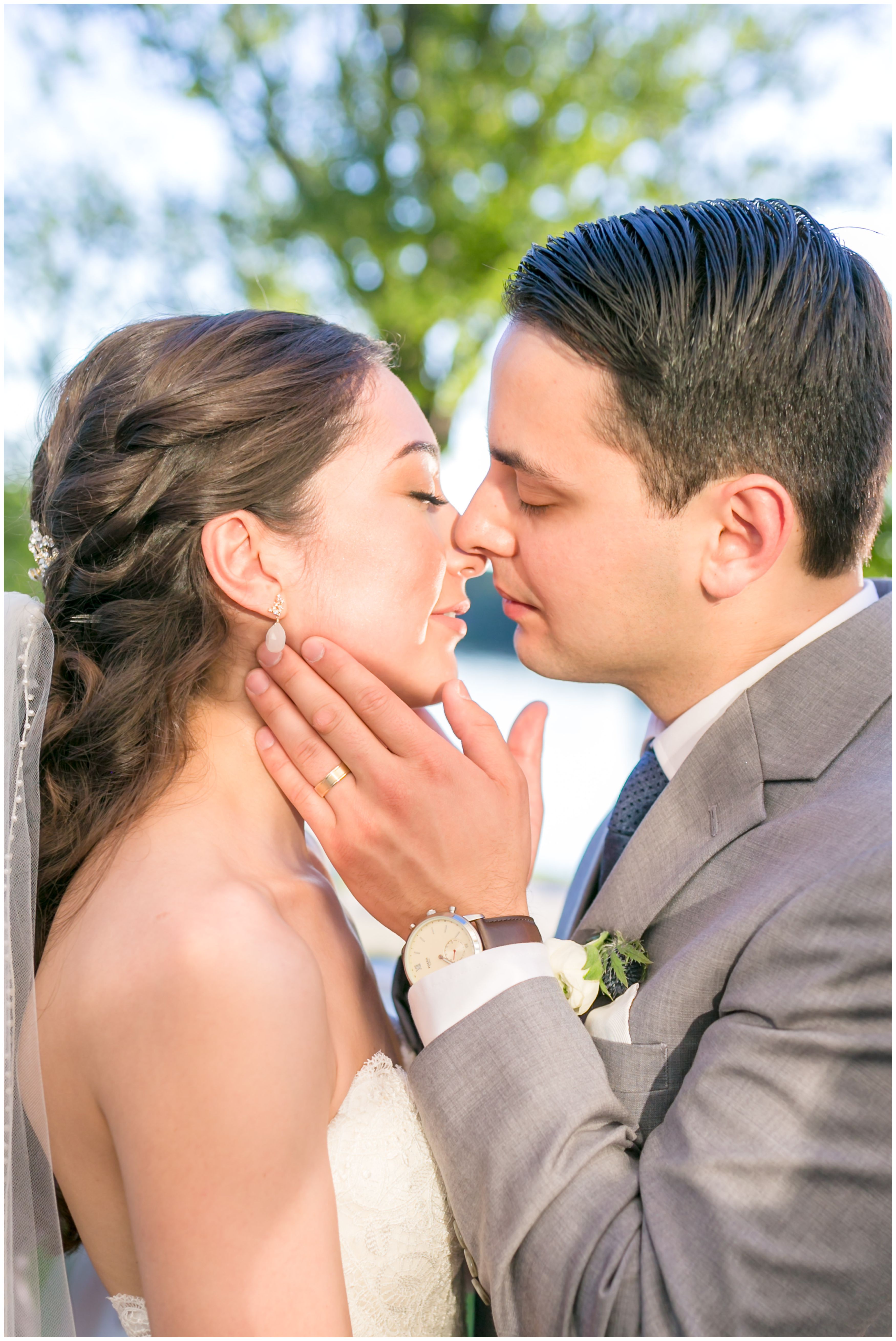 Bride and groom portrait almost kiss at outdoor lakeside wedding
