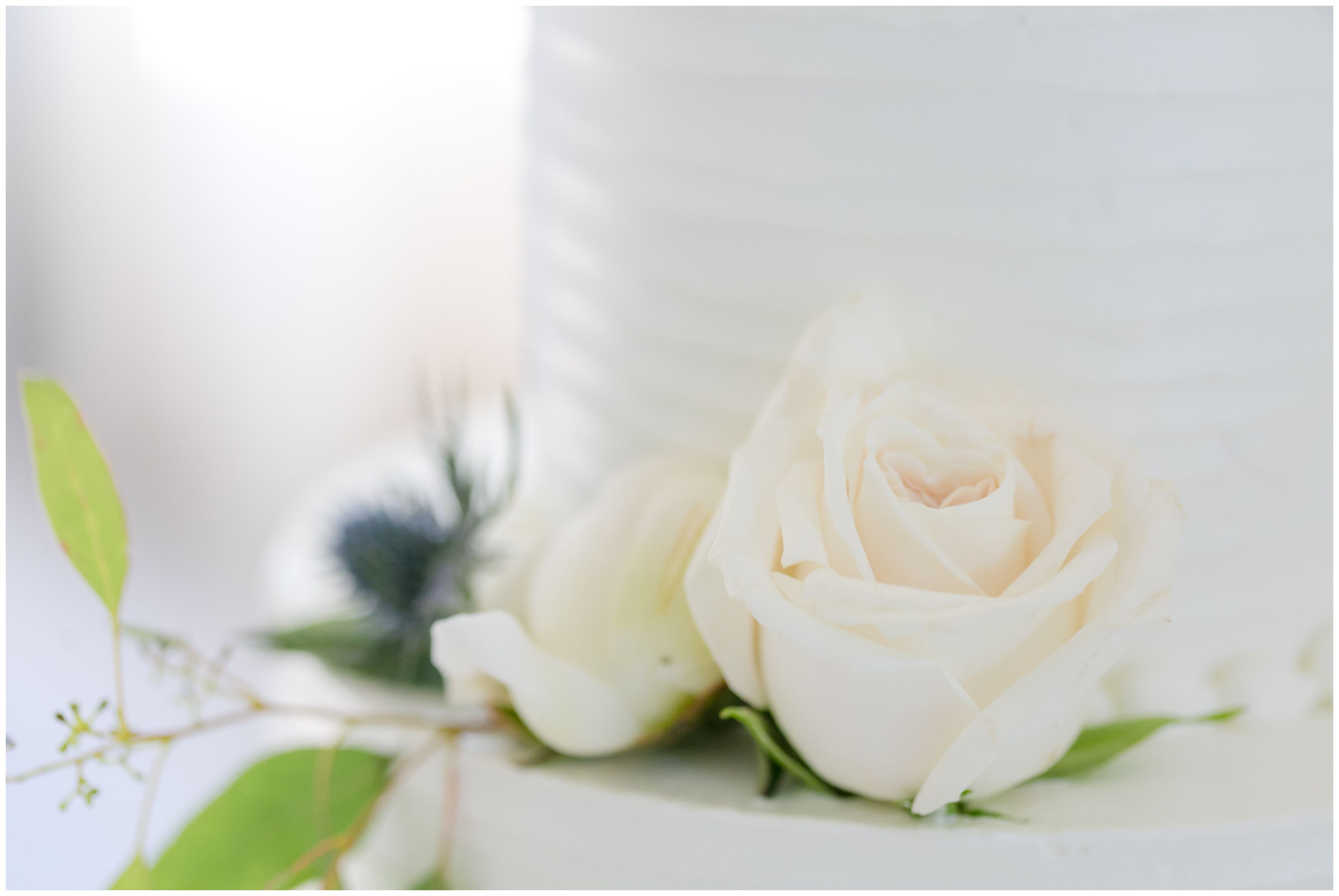 Wedding cake white roses and greenery