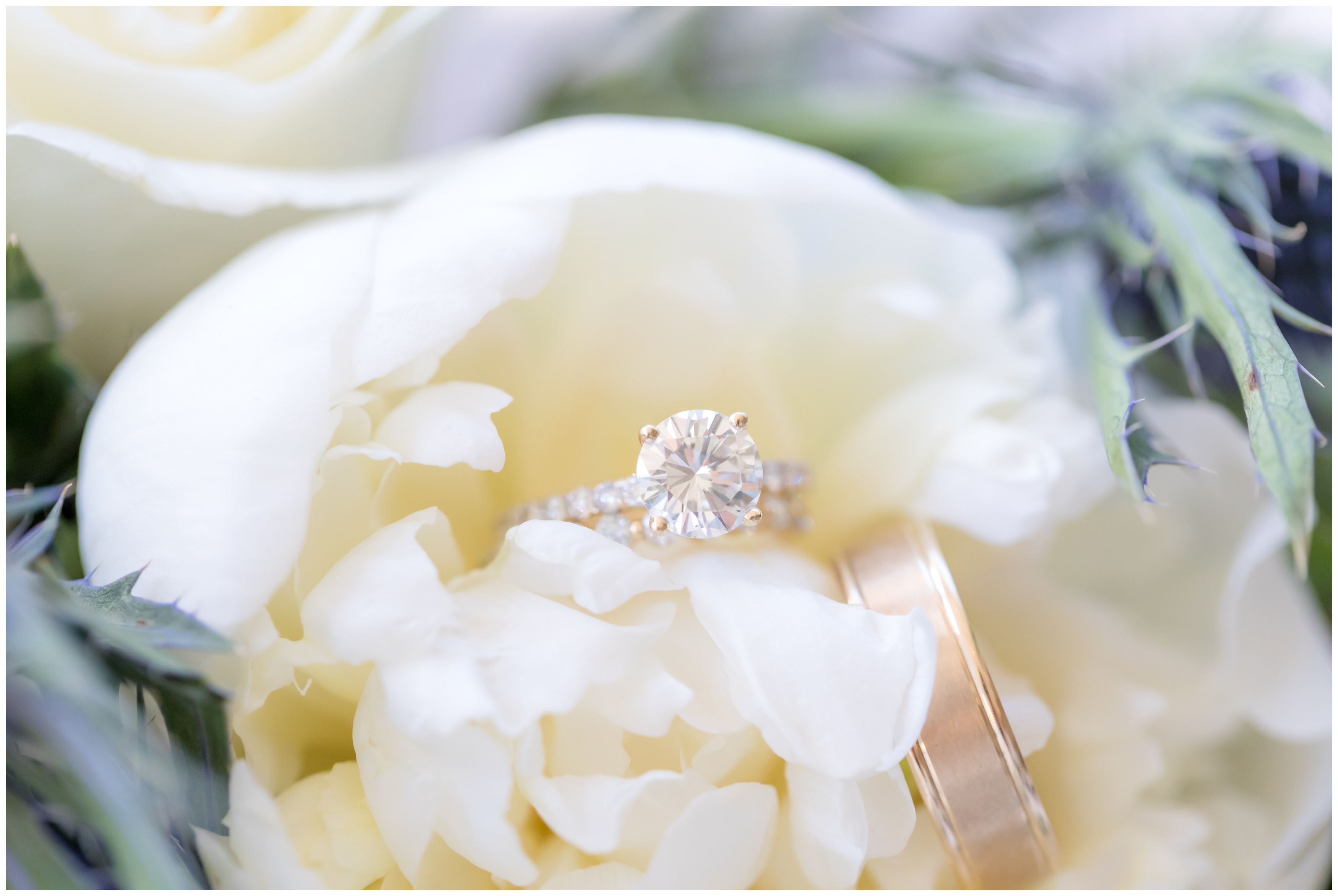 Classic gold wedding ring bands in white peony bridal bouquet